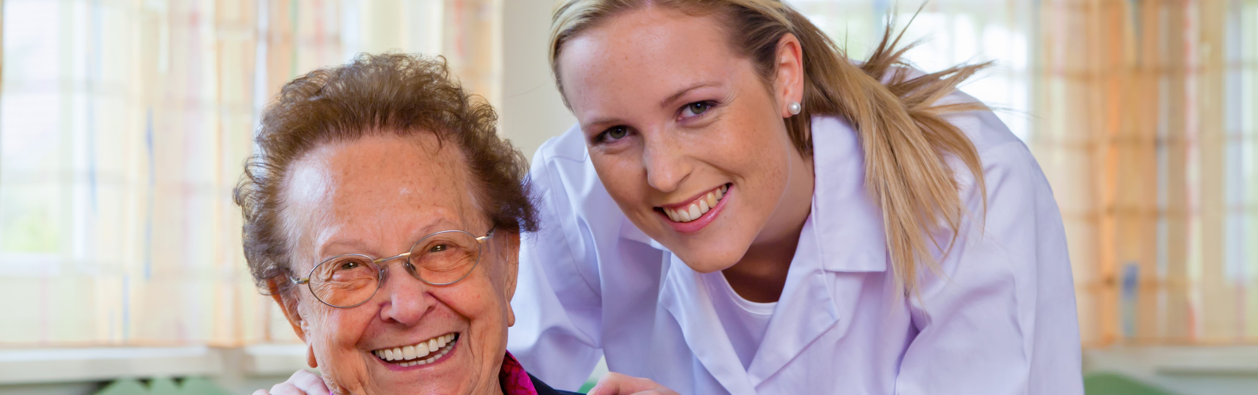 Foto met een vrolijke oudere dame en een verpleegster
