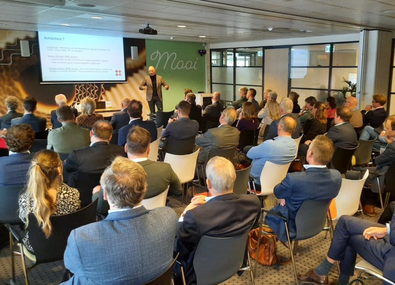 Bestuurders en ambtenaren luisteren naar presentatie over BRE-onderzoek